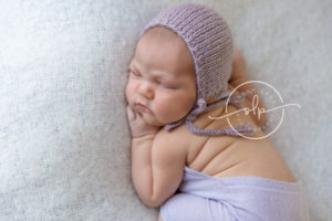 baby girl in purple bonnet