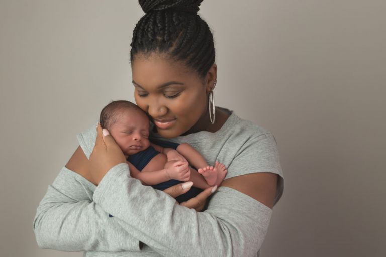 mother holding sleeping newborn