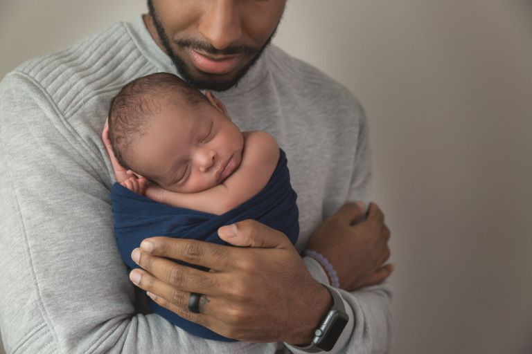close up of father holding sleeping baby boy