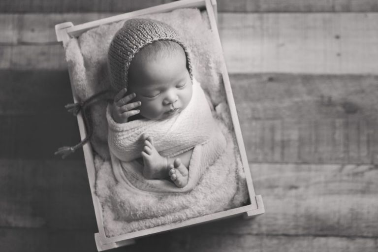 black and white image of sleeping newborn