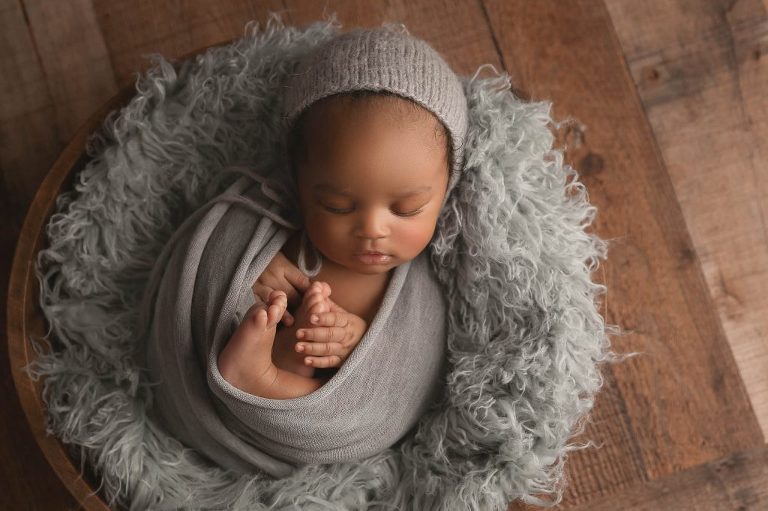 sleeping baby wrapped in gray with gray bonnet