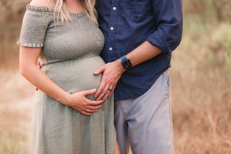 couple expecting a baby-when to book a newborn session